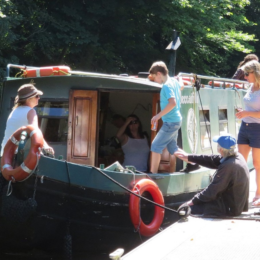 People on back of the boat and a dock